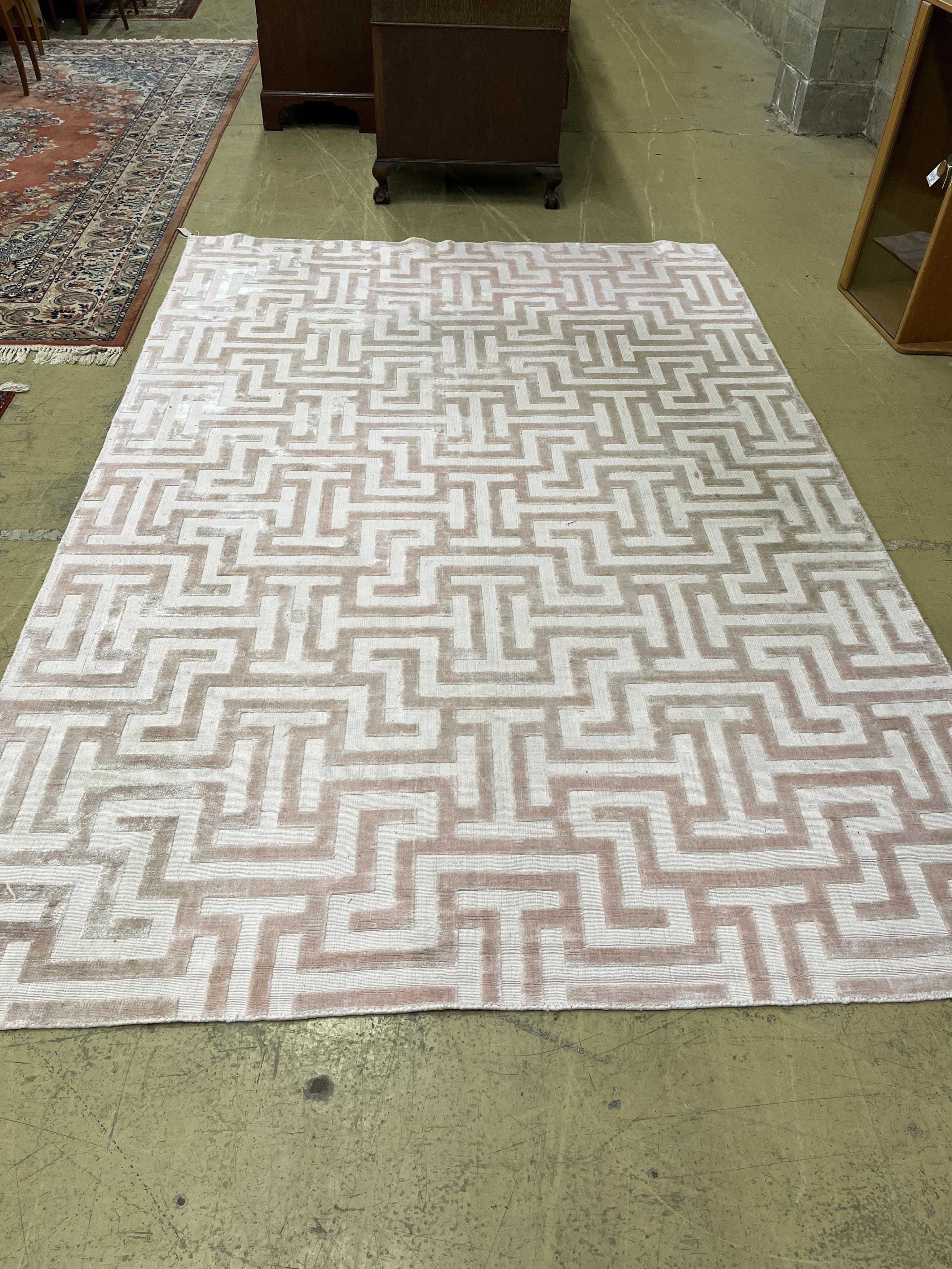 A Contemporary geometric pink ground carpet, 300 x 200cm. Condition - fair